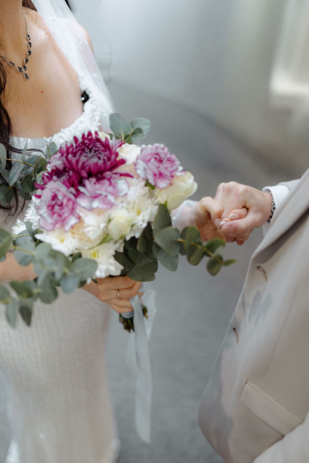 A delicate floral crown made with pink and white flowers and eucalyptus leaves for a wedding.