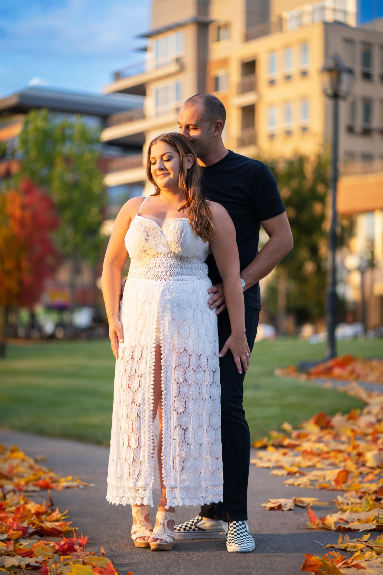 A couple poses together on a path for an engagement session