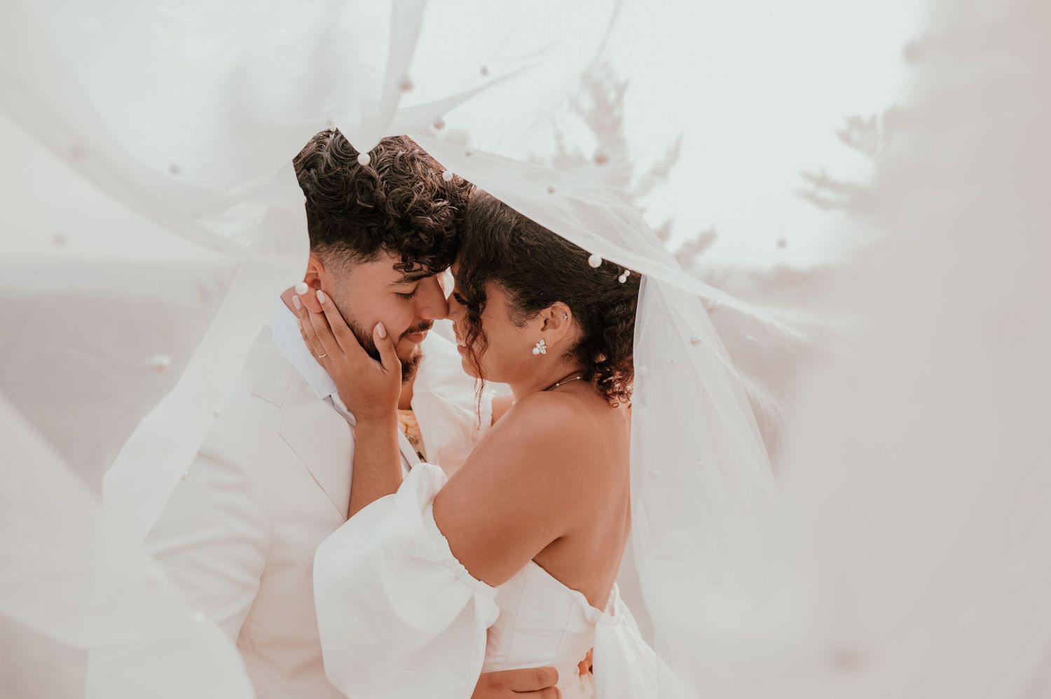 A tender wedding ceremony moment showing the couple embracing during their outdoor celebration.
