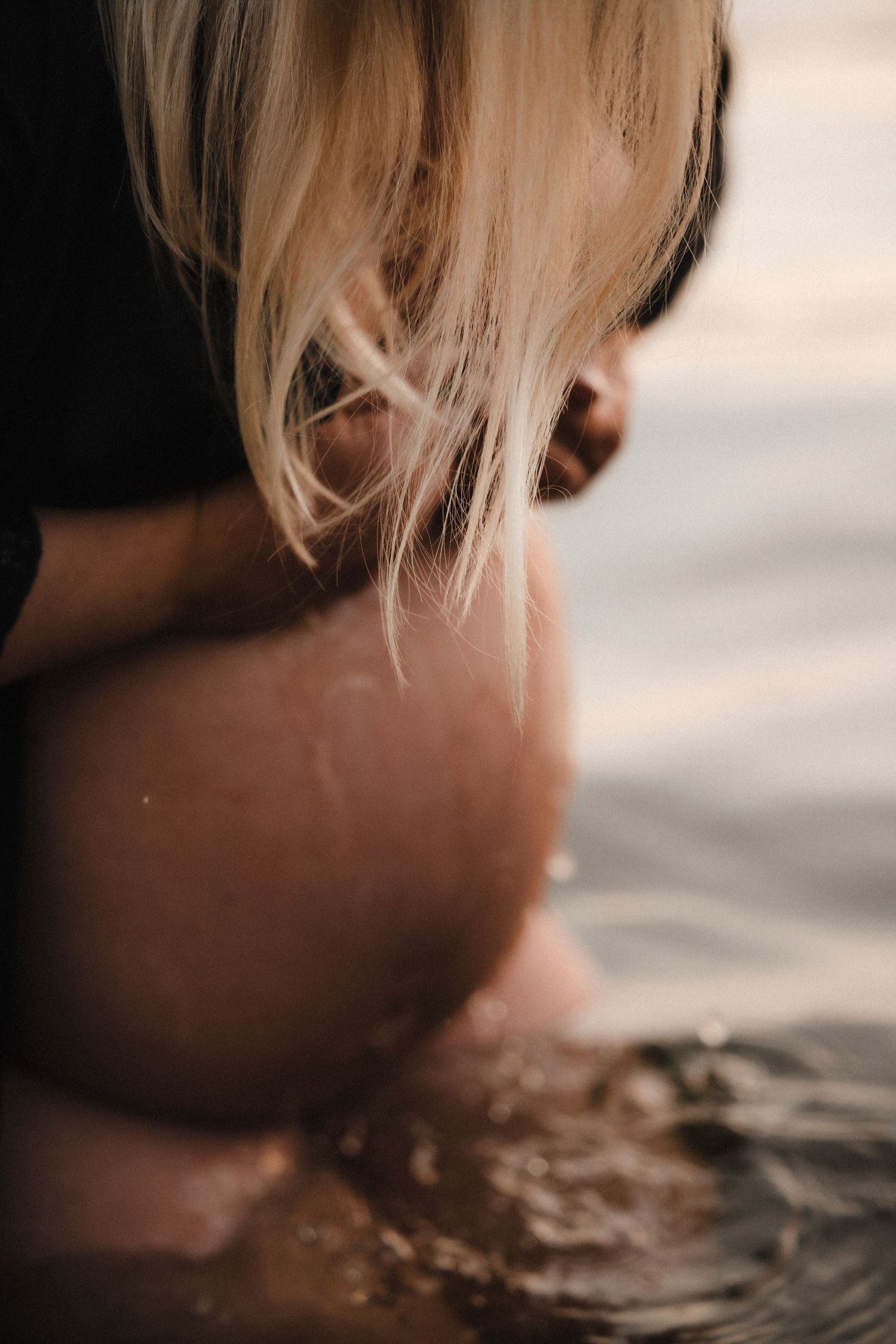 Close-up artistic photo series showing blonde hair dipping into rippling water with soft lighting and reflective surface.
