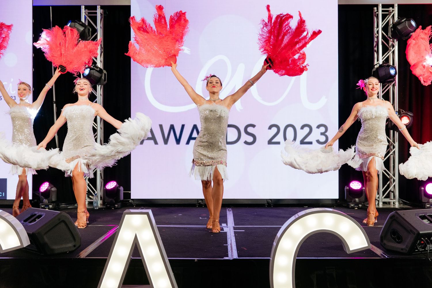Dancers on stage at an awards night entertaining the guests