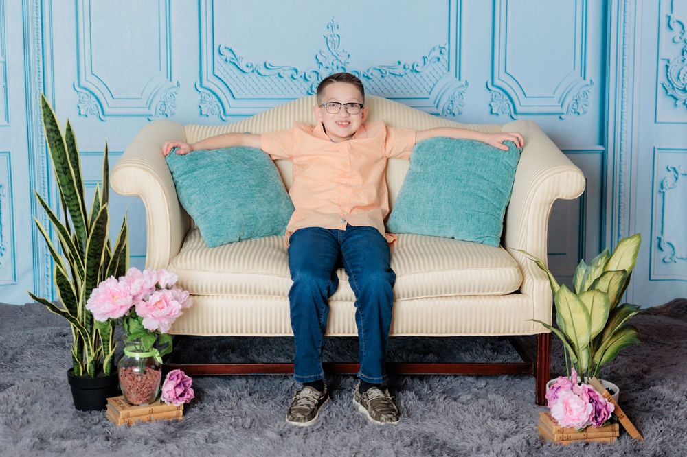 A series of cropped photos showing legs sitting on a vintage couch with blue walls and pink peonies as decor.