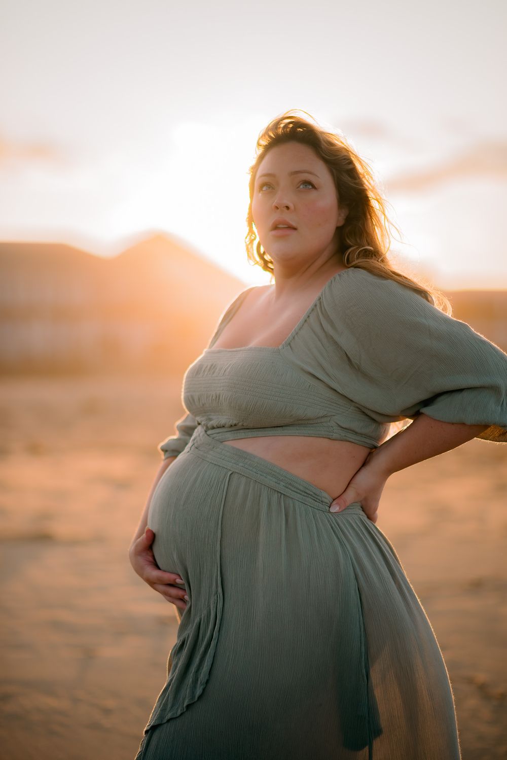 powerful image of pregnant mom backlit by the sun during maternity photoshoot