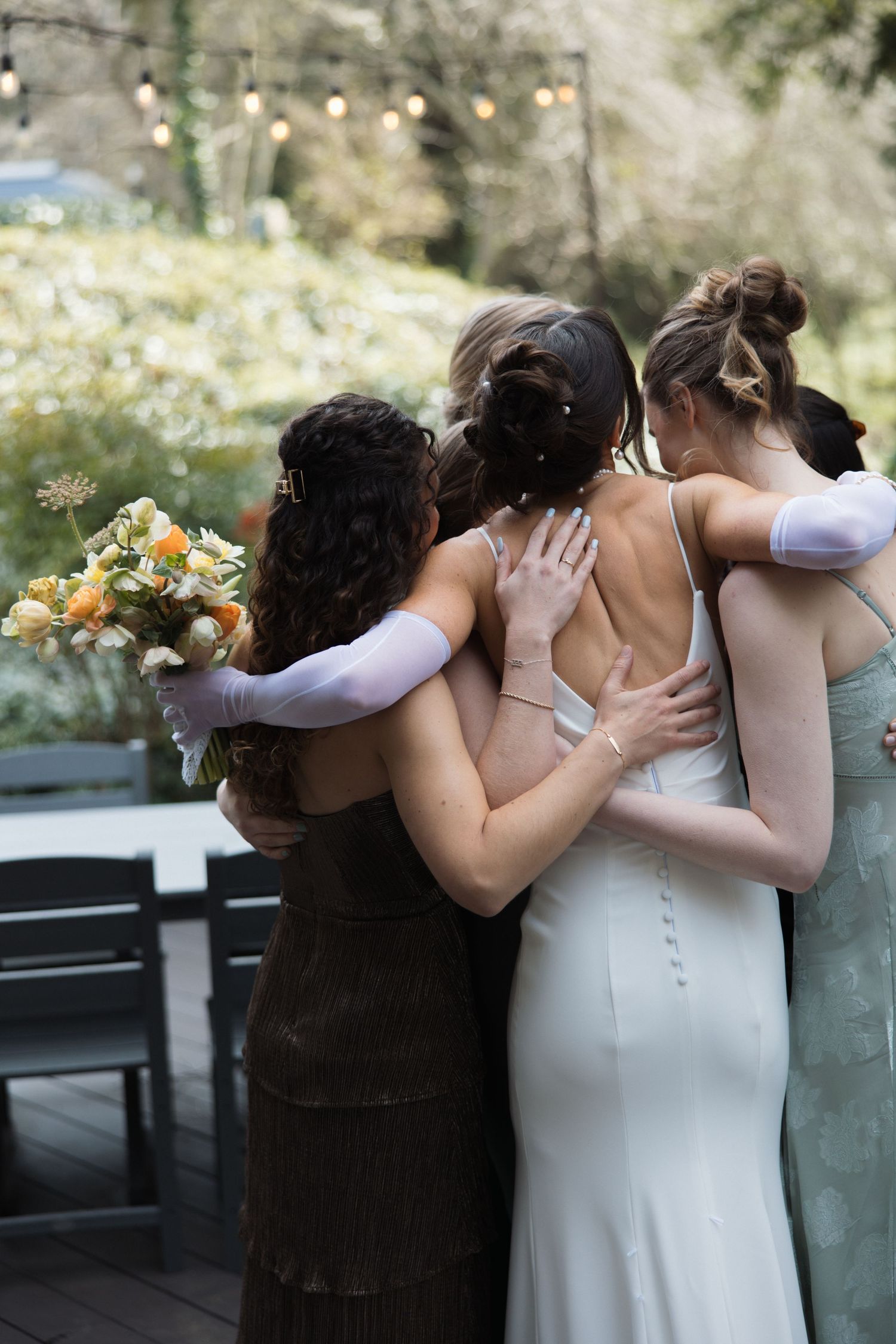 Bride hugging her bridesmaids during a getting ready moment at Sand Rock Farm in Aptos, California