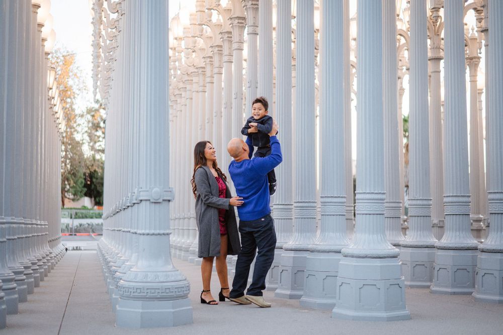Elegant white columns create a symmetrical architectural corridor with natural lighting.