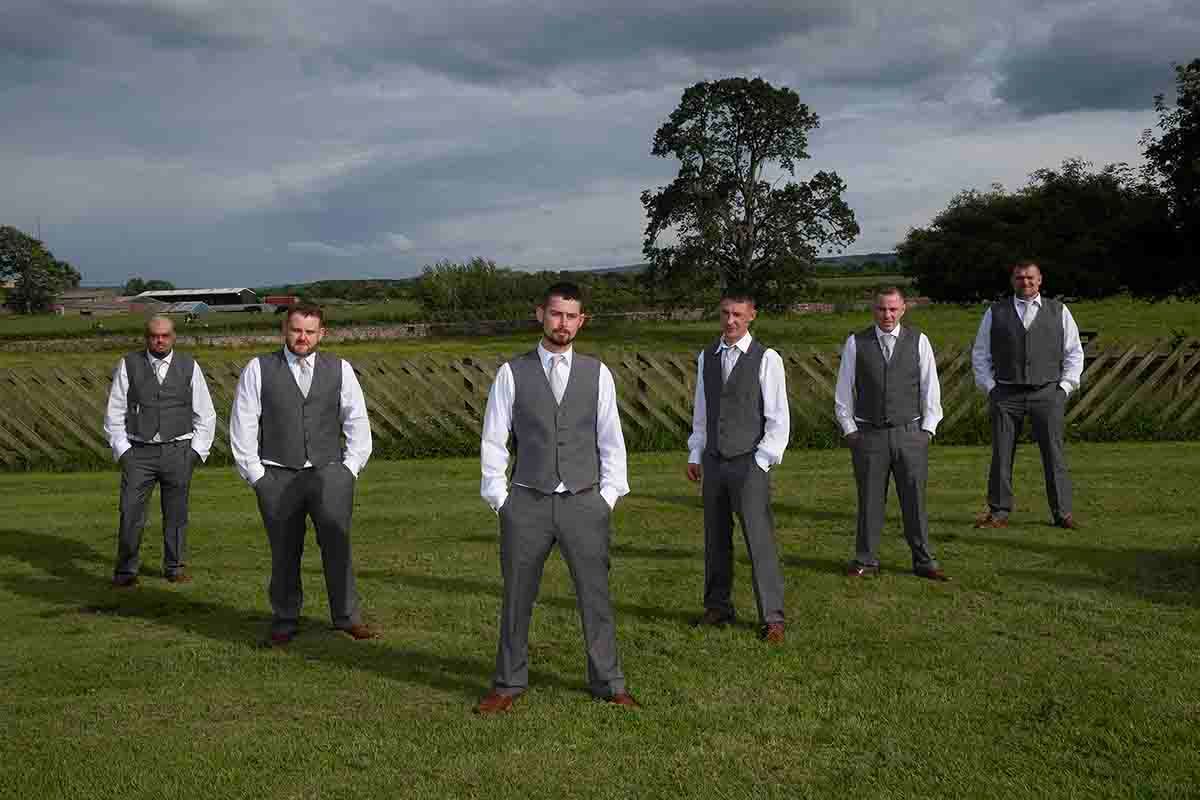 The Groom & five groomsmen  pose on the lawn at Greenhill Hotel near Wigton on the wedding day