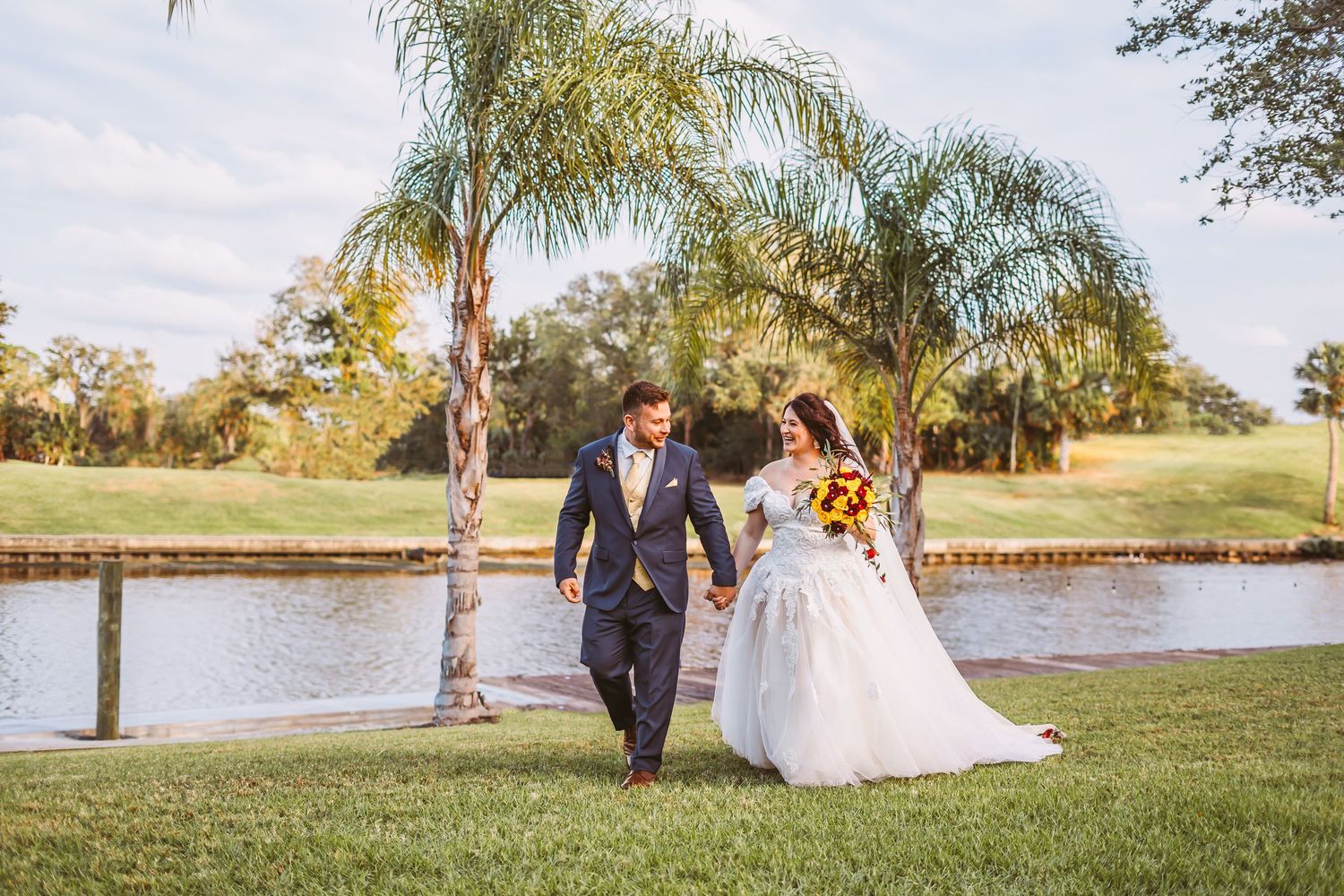 Channel Side Club in Palm Coast Florida. Wedding photography of Bride and groom walking by the water.