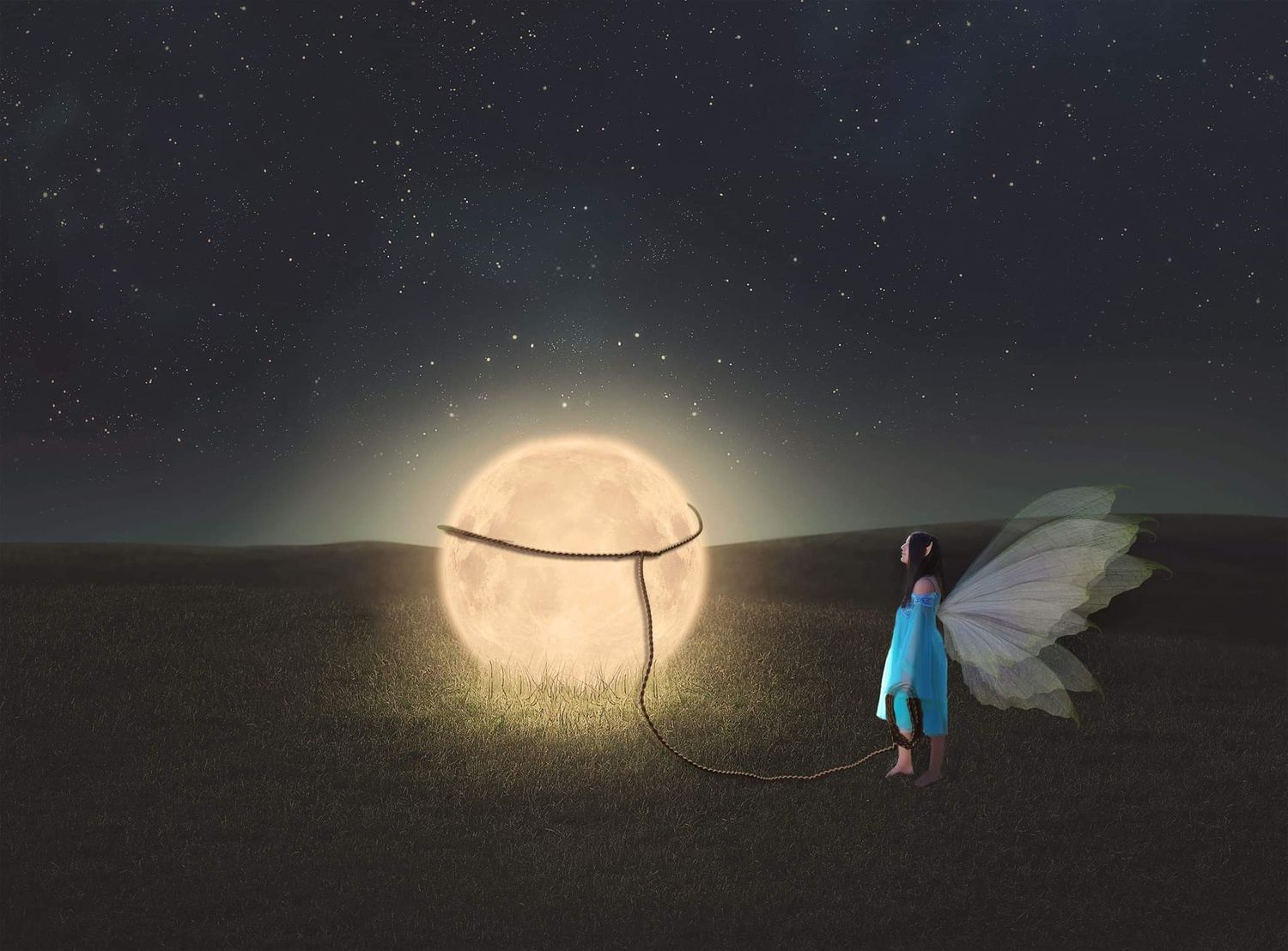 Fairy girl with delicate wings holding a string tied to a glowing full moon resting on a grassy field under a starry night sky.
