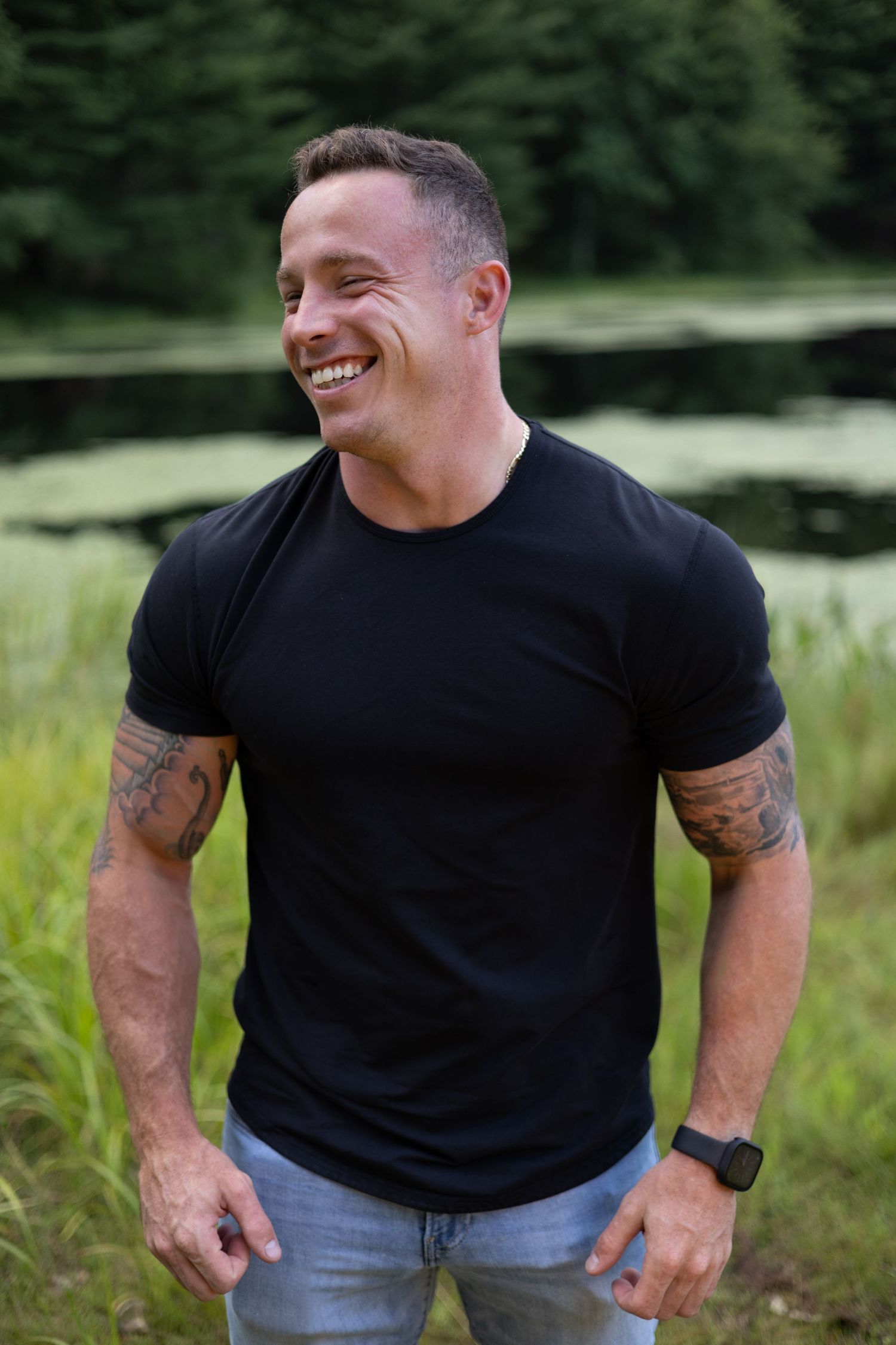 Candid portrait of a man smiling near a pond