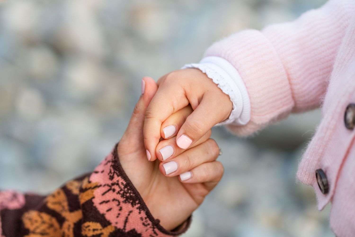 Mom holding her daughter's hand.