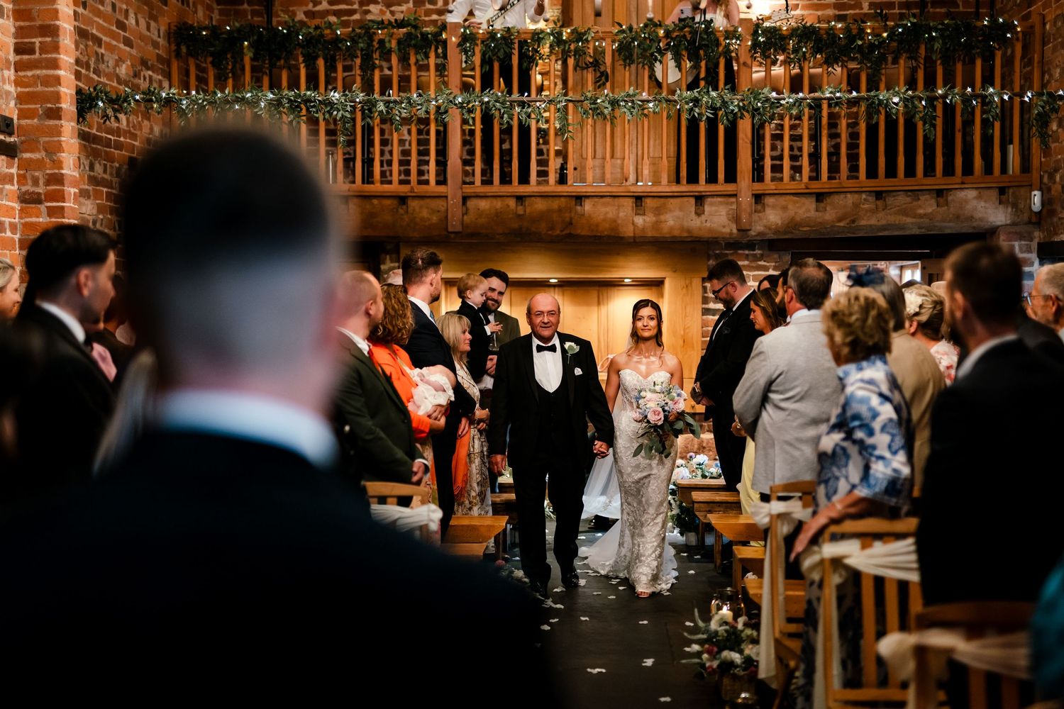 Bride walking down the aisle with her father at Curradine Barns