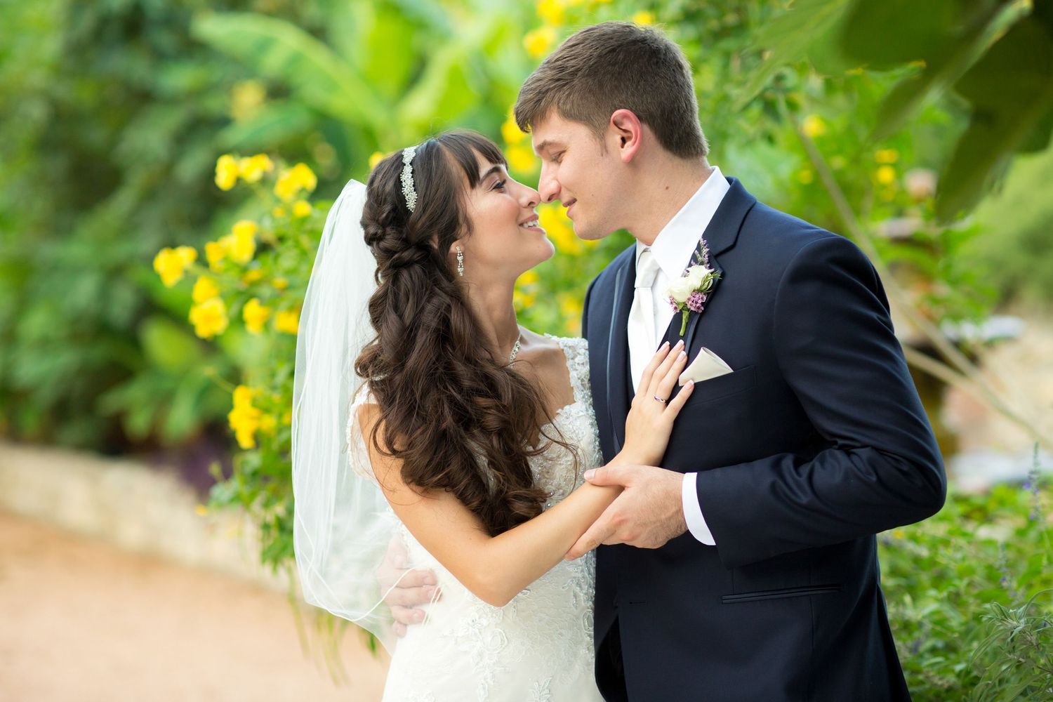 Romantic wedding couple portrait series in a lush garden setting.