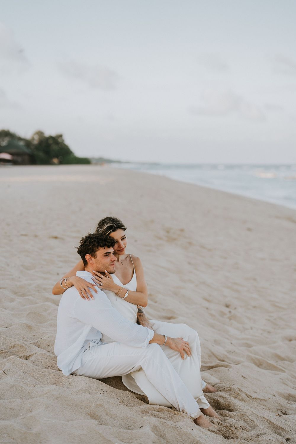 Secret proposal at Nusa Dua Beach Bali during golden sunset with ocean backdrop