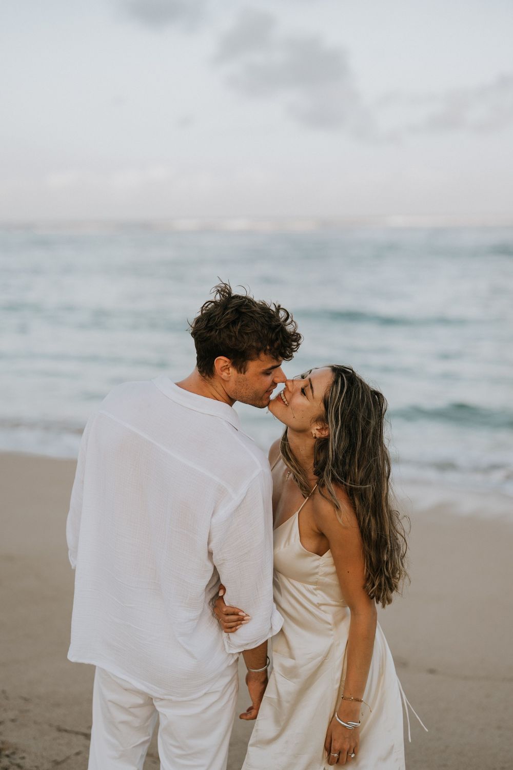Secret proposal at Nusa Dua Beach Bali during golden sunset with ocean backdrop.