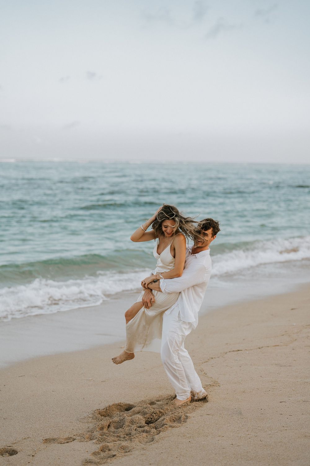 Secret proposal at Nusa Dua Beach Bali during golden sunset with ocean backdrop