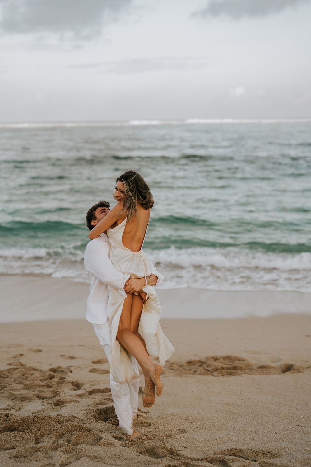 Secret proposal at Nusa Dua Beach Bali during golden sunset with ocean backdrop