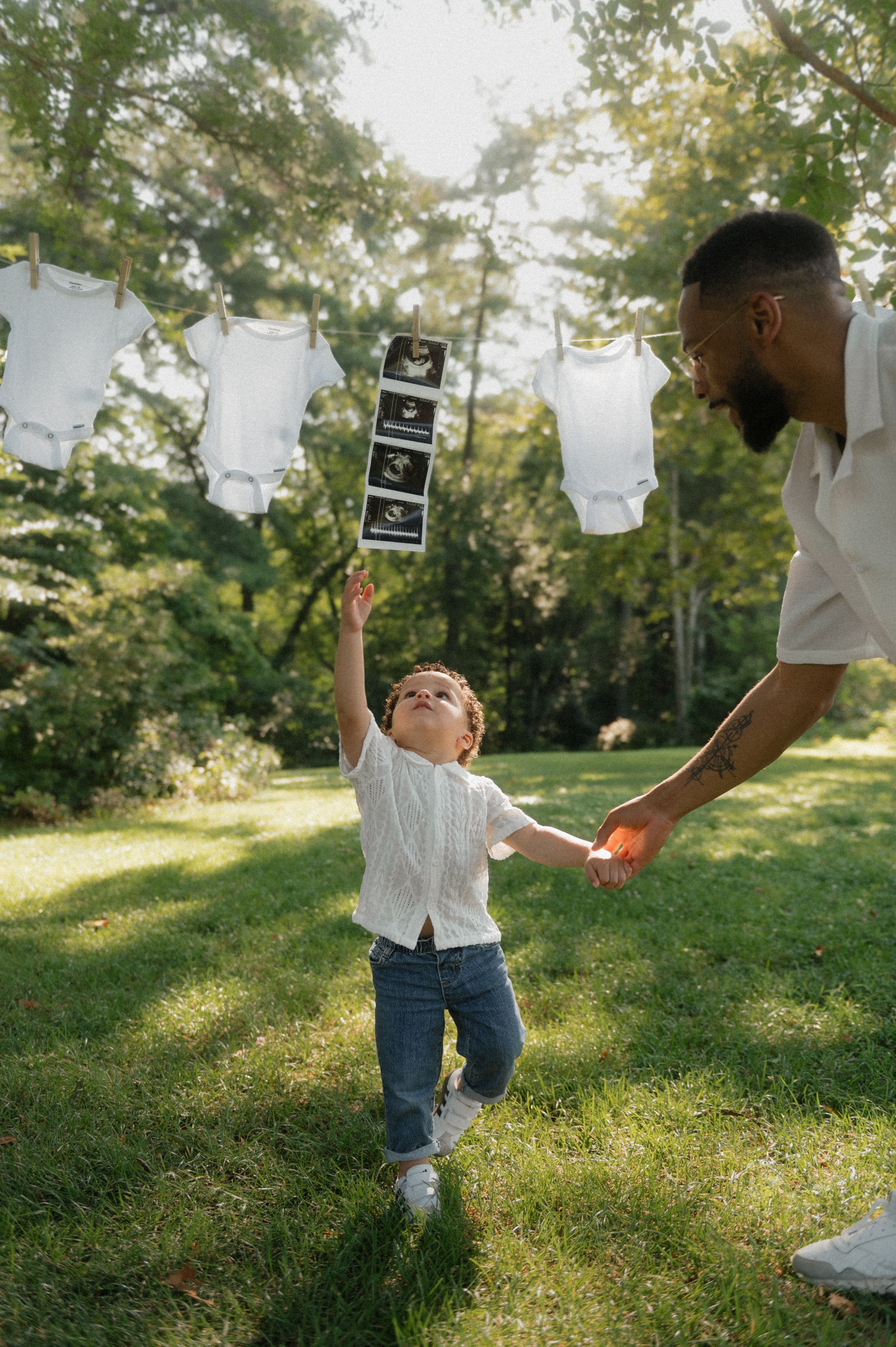 A series of photos showing hands holding ultrasound photos in a sunny outdoor setting with green grass.