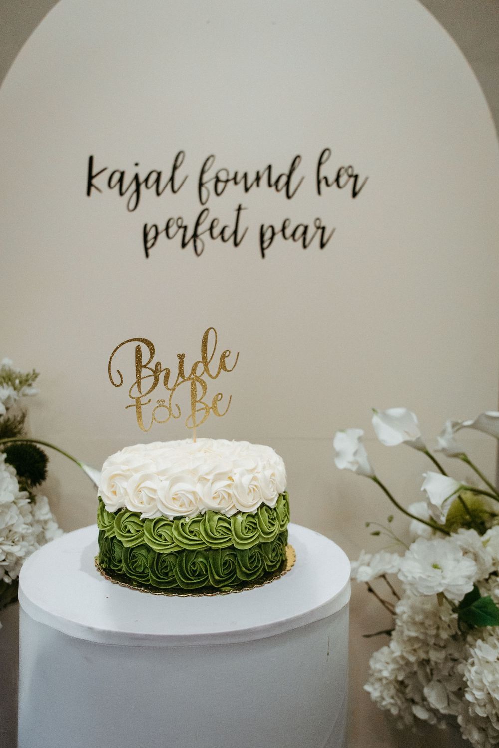 Bride-to-be cake with ombre green frosting and white florals at a Central NJ bridal shower
