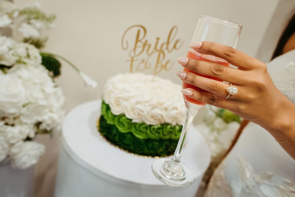 Bride-to-be cake topper with champagne toast and engagement ring at a New Jersey bridal shower