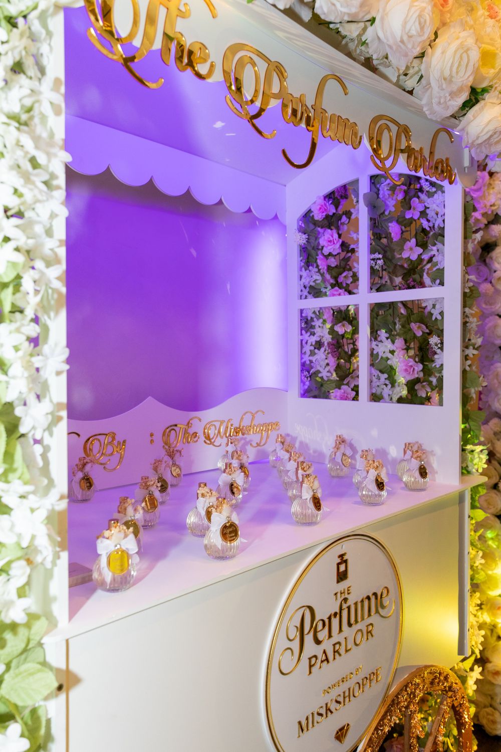 Custom perfume bar display with gold signage at a bridal shower in New Jersey
