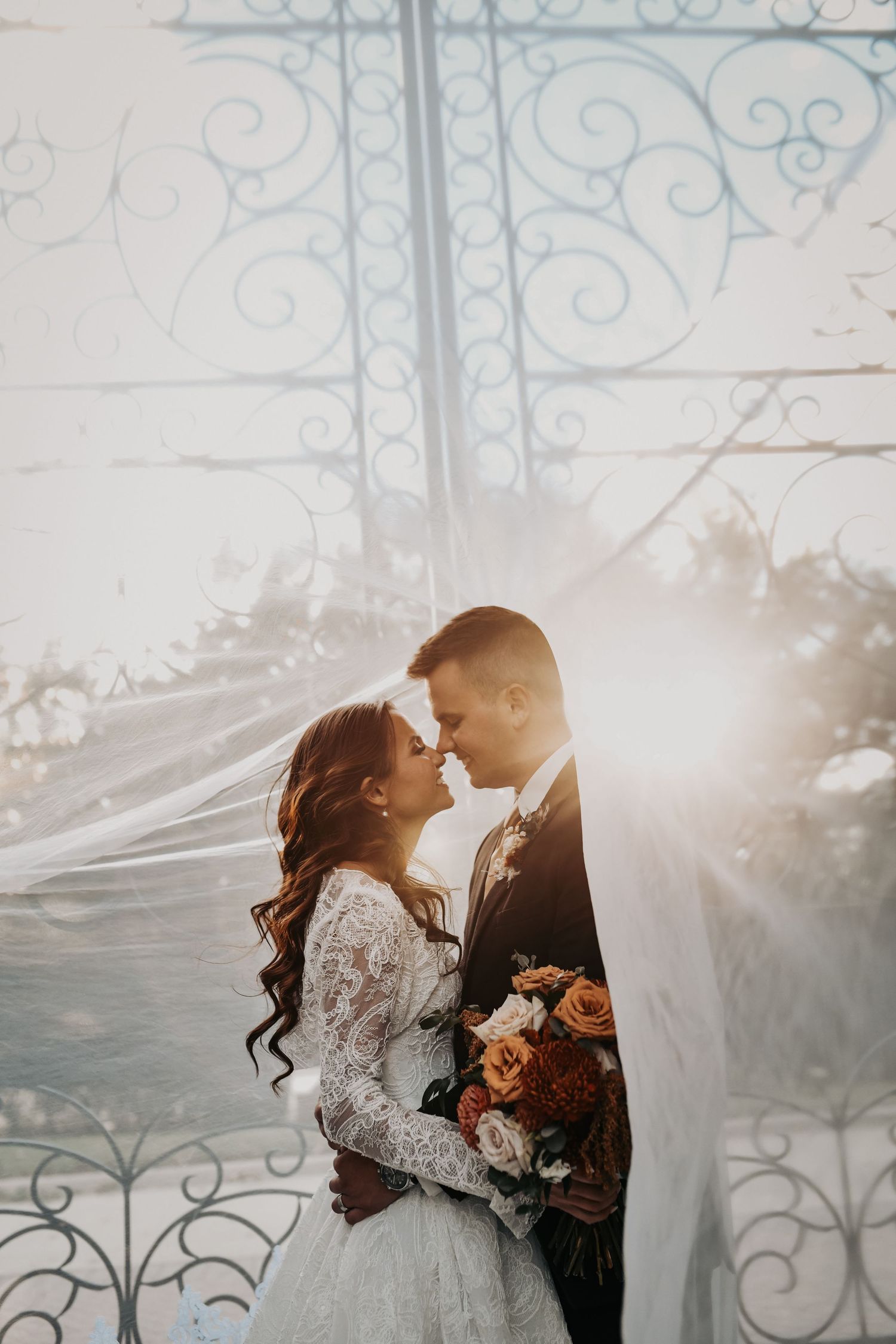 Romantic Catholic wedding portraits of ride and groom under the veil in Coppell Texas