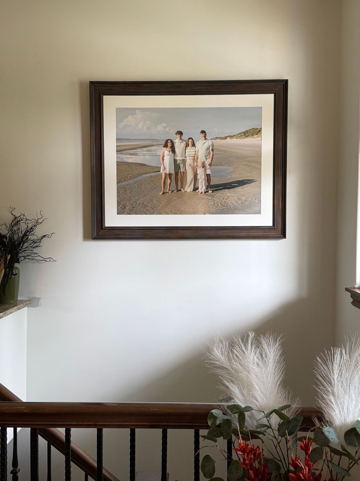 Large custom framed family vacation portrait from Jekyll Island displayed in the family’s home. Photographer serves Amelia Island, Kingsland