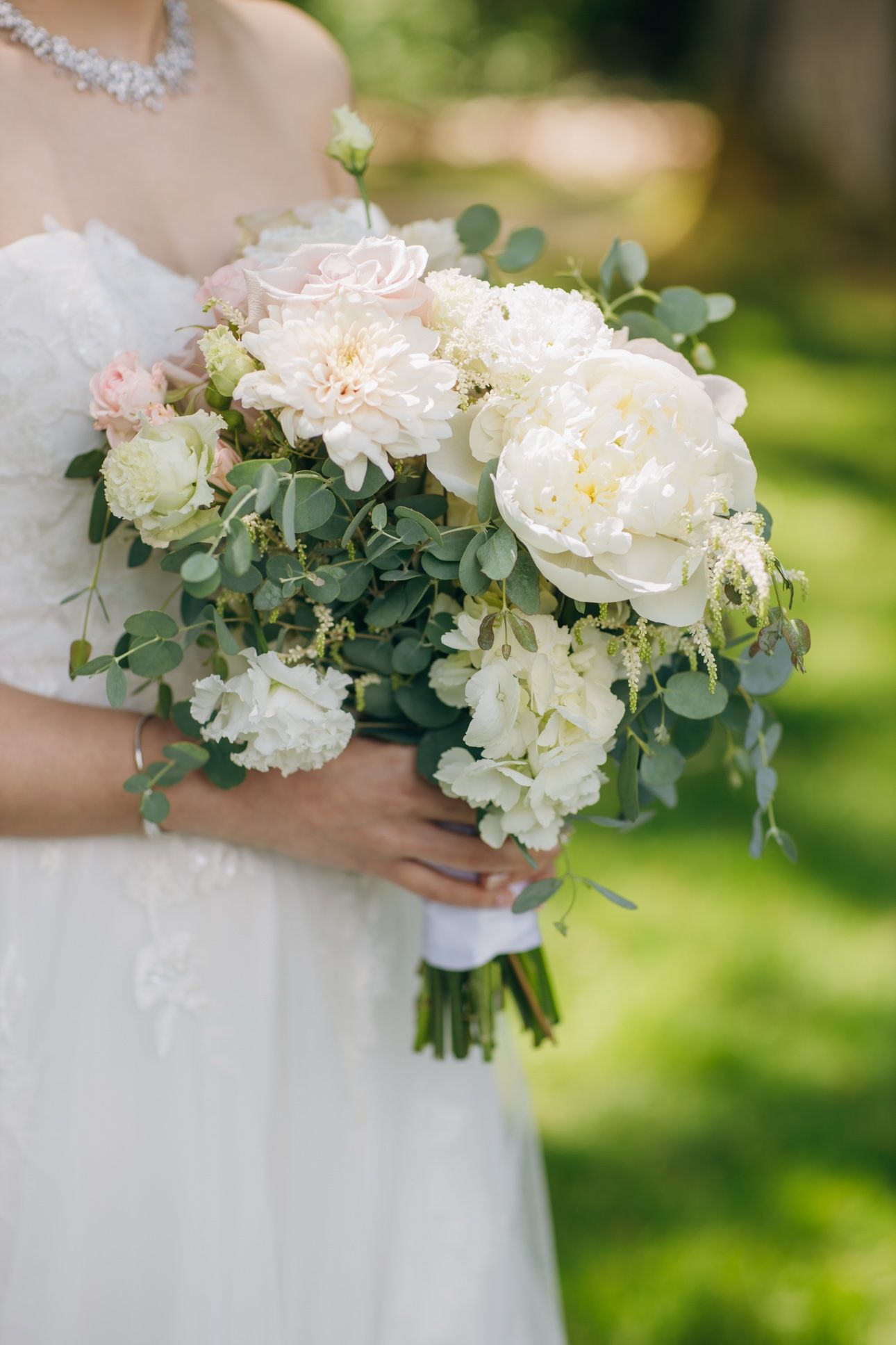 Bride's bouquet of blush peonies, roses and eucalyptus at a spring wedding in Vancouver