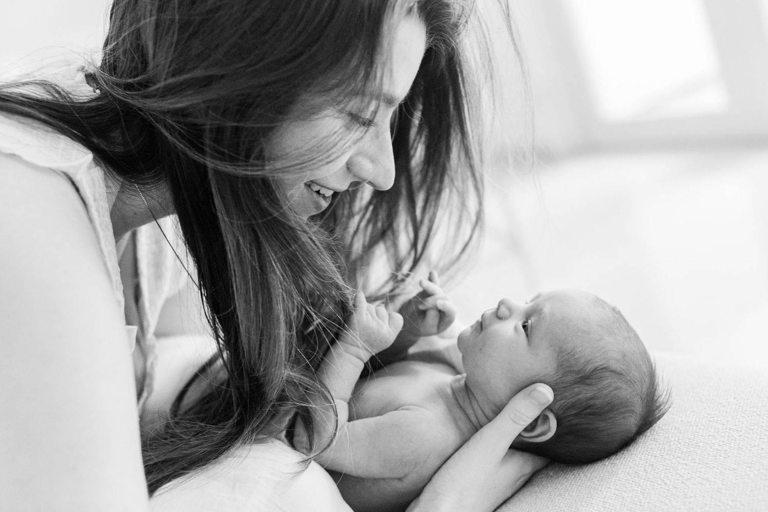 Black-and-white portrait of a mother and newborn. In-home lifestyle newborn session in Guaynabo, Puerto Rico.
