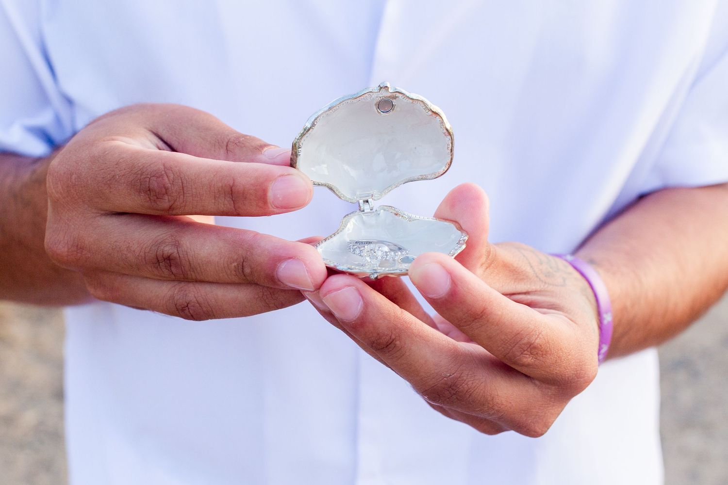 Marriage proposal. Man presenting the ring in a shell presentation box. Río Grande, Puerto Rico.