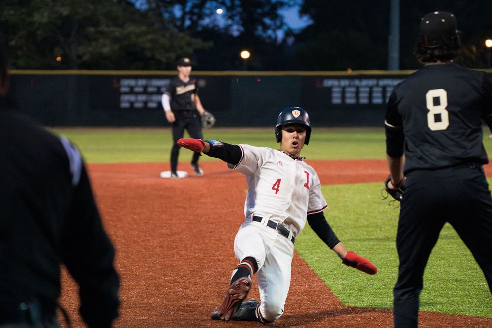 OLu baseball player makes contact with the ball during a swing at home plate, captured by Chris Cornish Photography.
