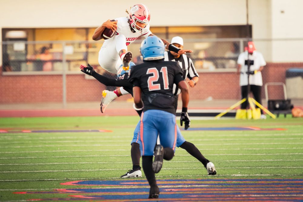 OLu football player sprints down the field with the ball during a varsity game, captured by Chris Cornish Photography.