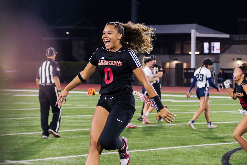 Orange Lutheran High School Flag Football Makena Cook runs off field joyful after game win in 2025 season