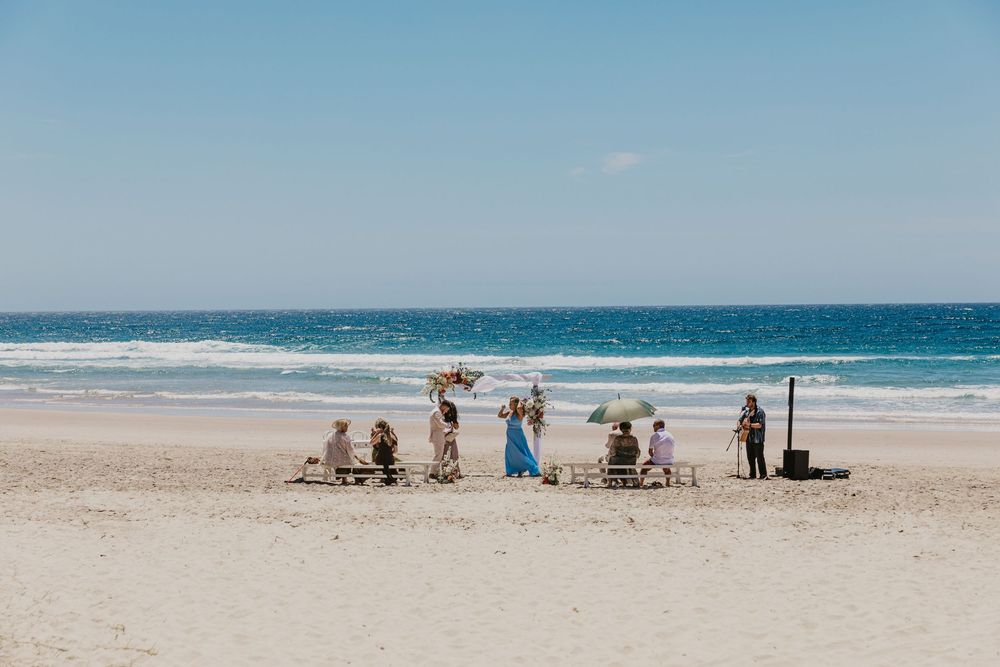 Guests celebrating an intimate Byron Bay beach wedding with stunning ocean views and a relaxed coastal ceremony.