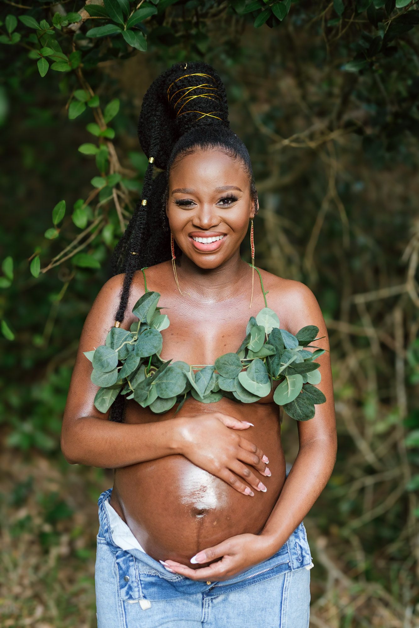 Pregnant woman standing in the forest during a maternity photography session