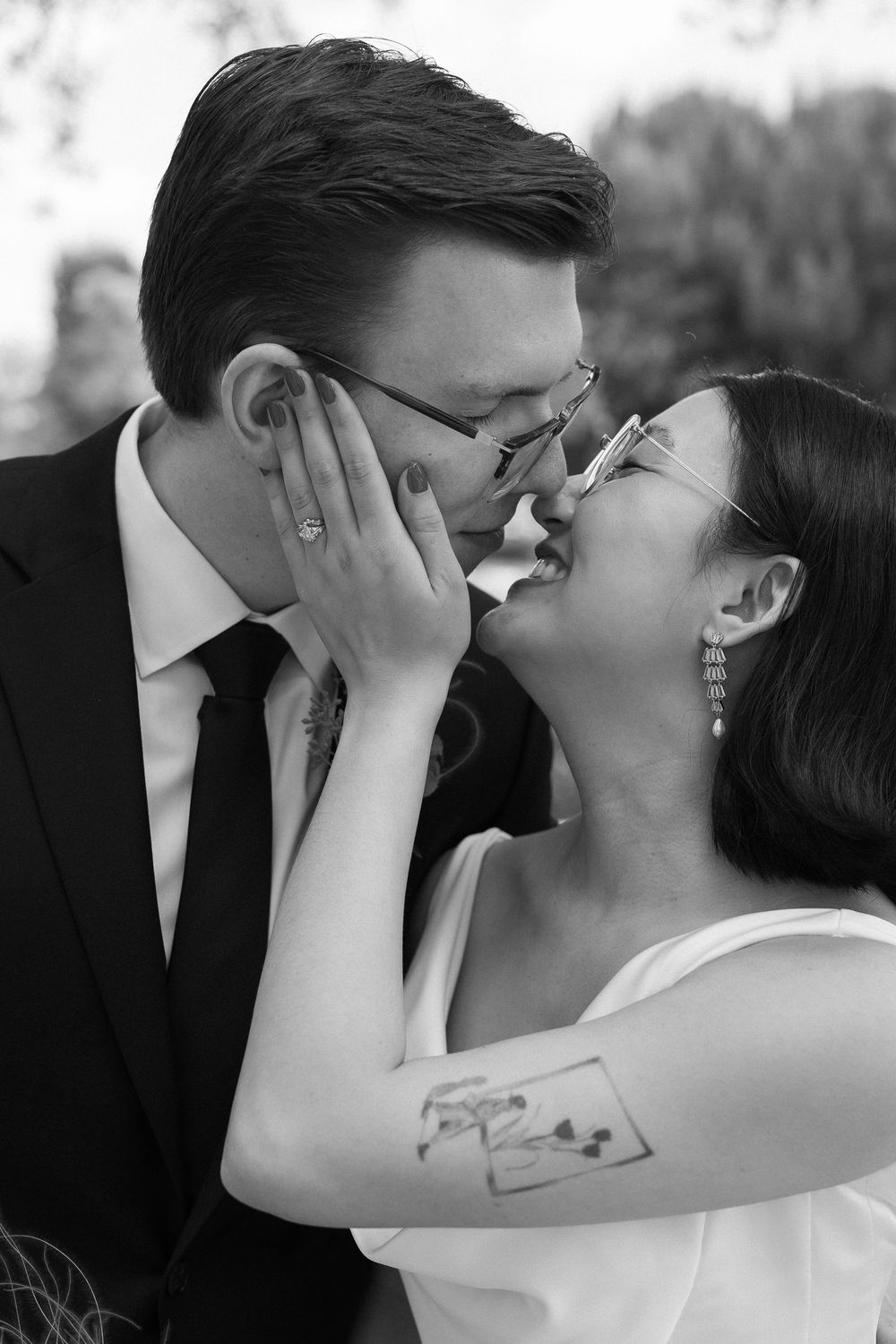 A couple in Laguna Beach share an intimate kiss captured on black and white editorial photography.