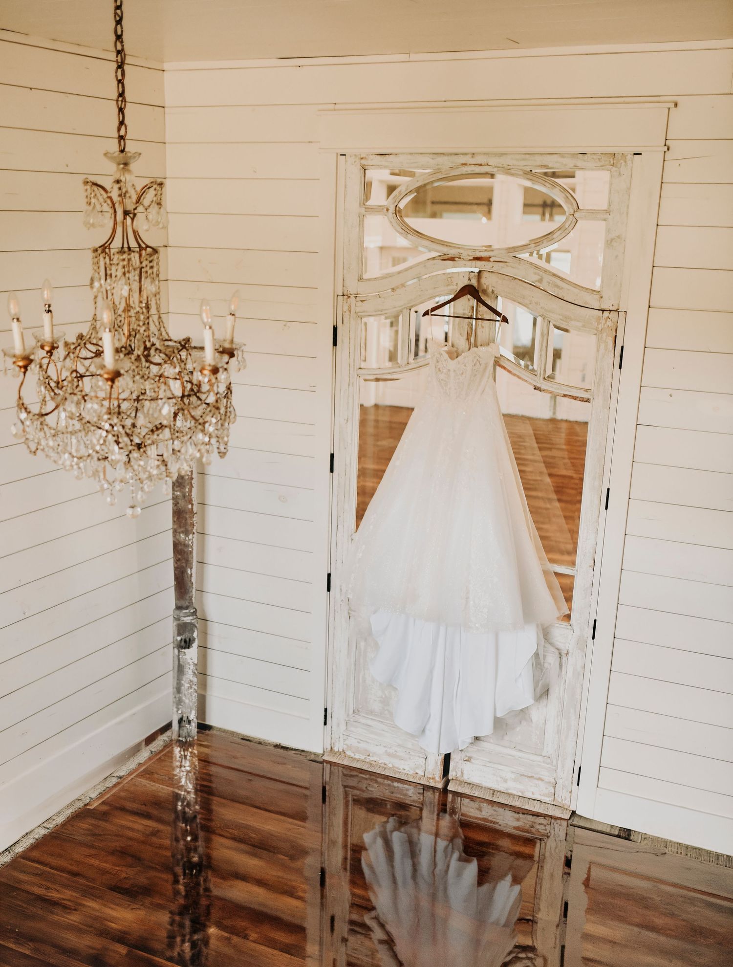 elegant wedding gown hanging on french doors