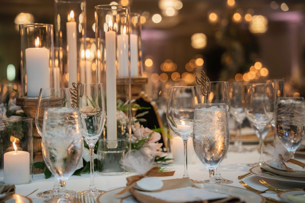Reception tablescape with tall candles and place settings at Pelican Club, Jupiter, FL