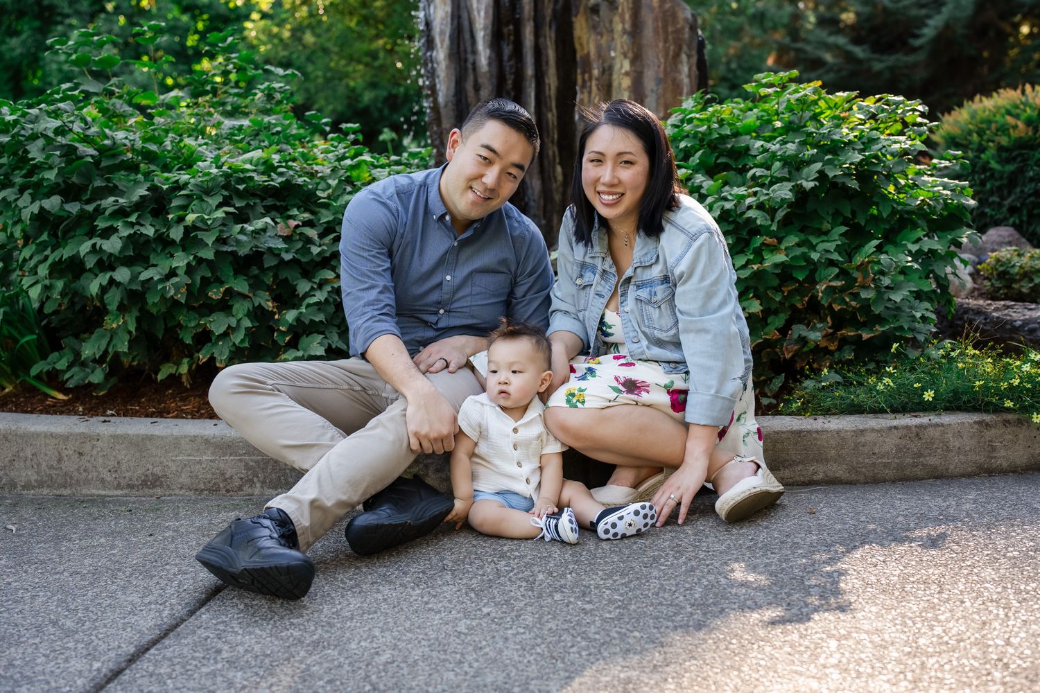 family portrait sitting by a park fountain