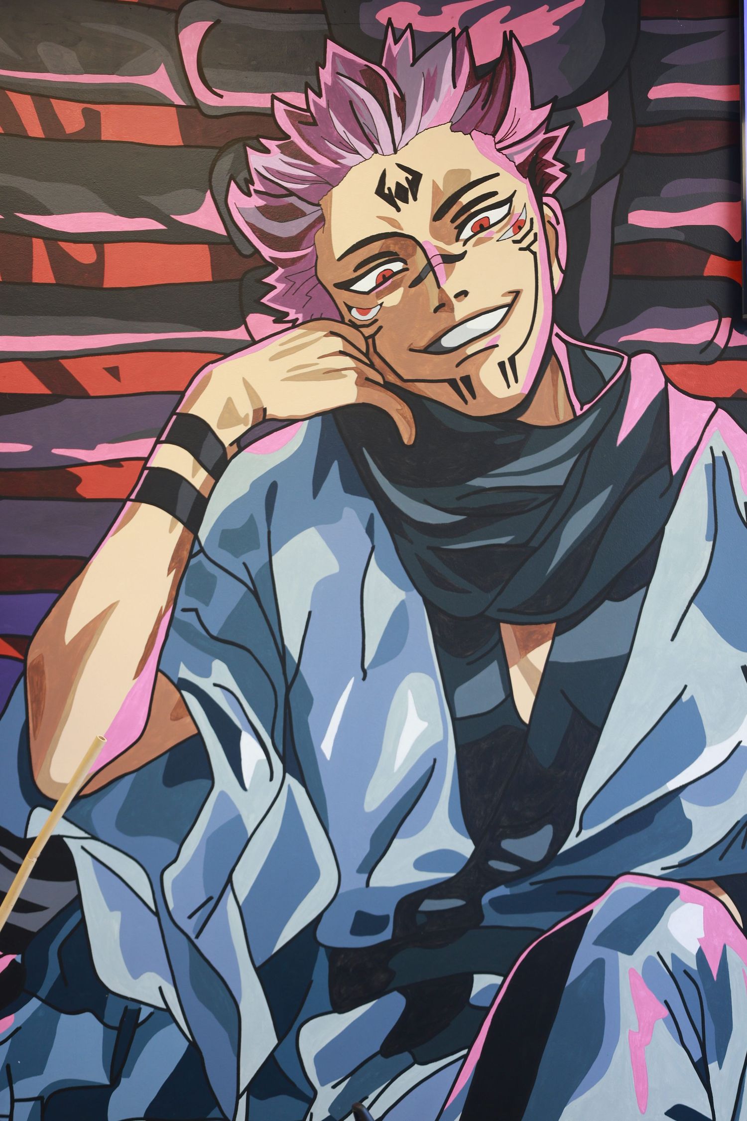 Anime character with pink spiky hair, facial tattoos, and a wide grin, wearing a blue kimono, posed confidently.