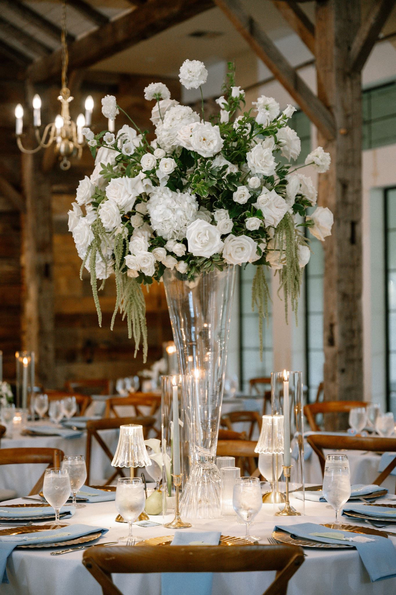 White floral reception table scape at Historic Hill House wedding venue in Willis Texas.