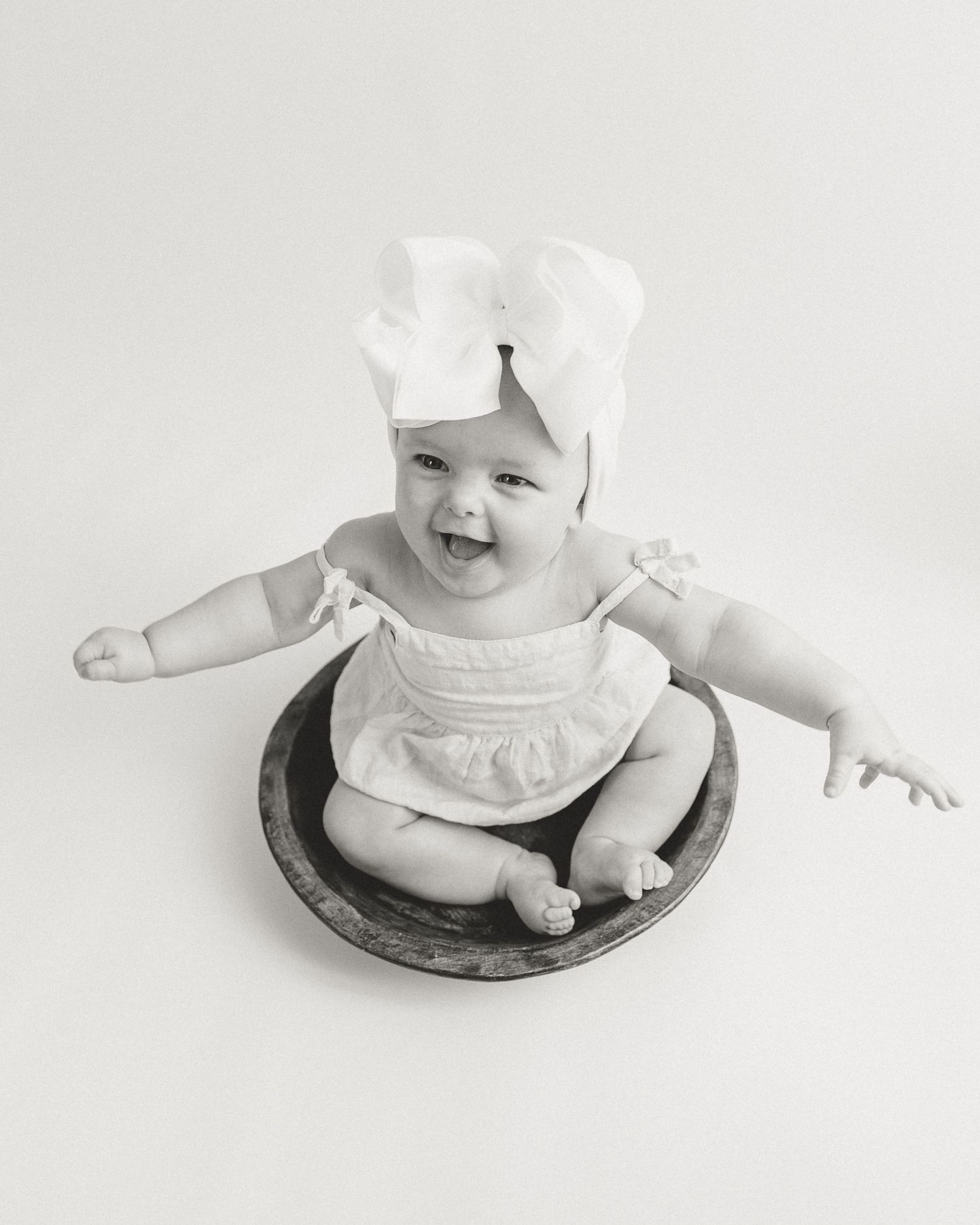 Black and white personality shots at 6 month old sitter session in Tyler Texas by East Texas Motherhood Photographer KP Portraits