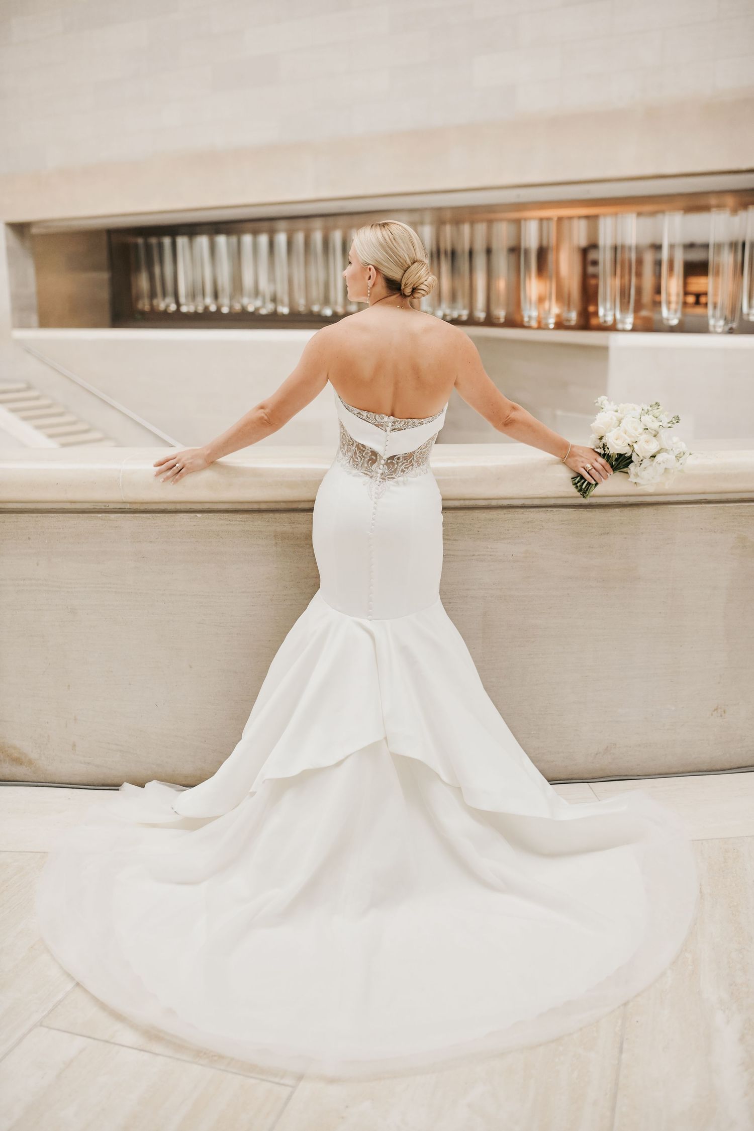 Full-length bridal portrait featuring an elegant wedding dress at the Meyerson Symphony Center