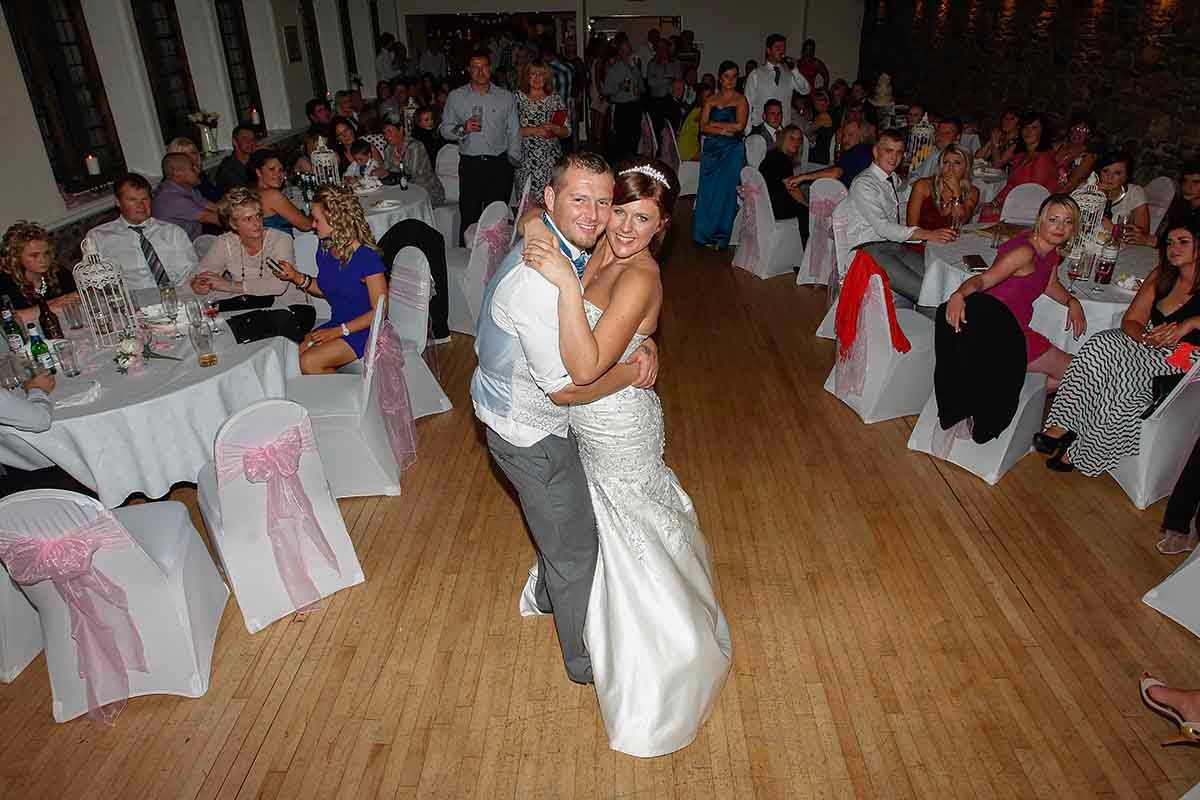 Bride and groom share first dance at wedding reception at Cockermouth in Cumbria - during their  wedding celebration