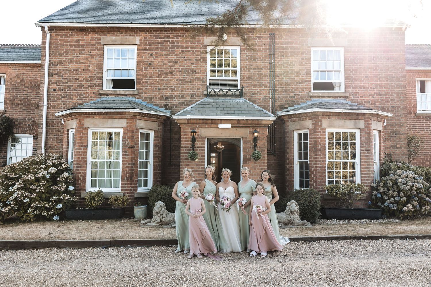 Bride and bridal party outside Swancar Farm Country House in Nottinghamshire