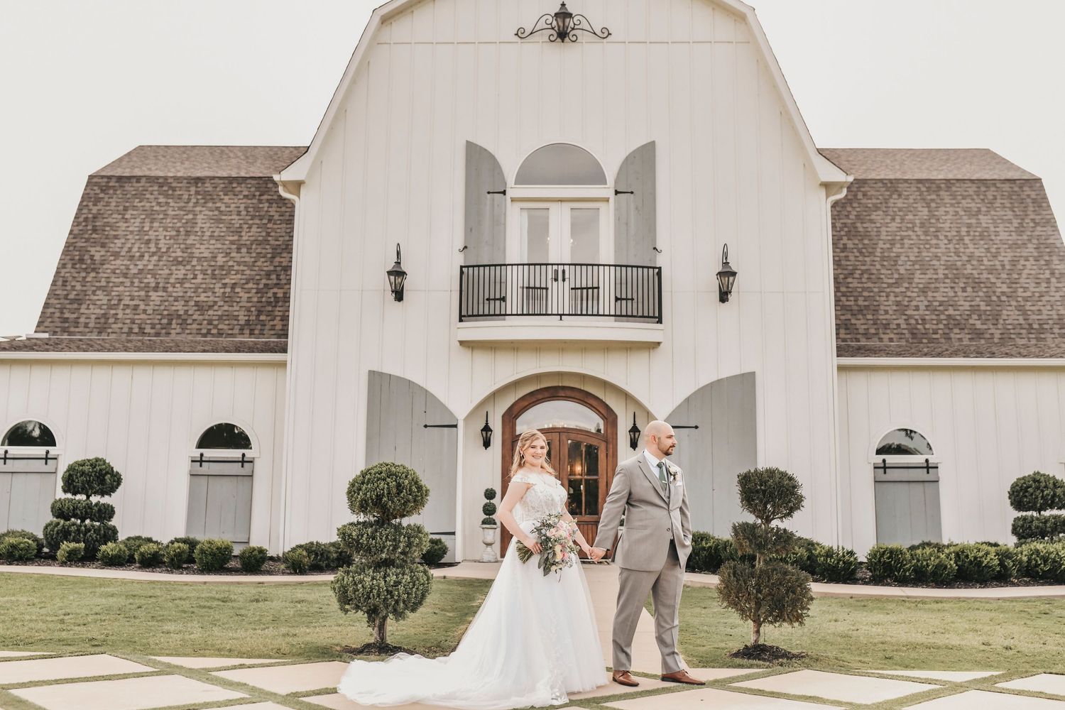Parker and Kathryn wedding portrait in front of The French Farmhouse in Collinsville Texas