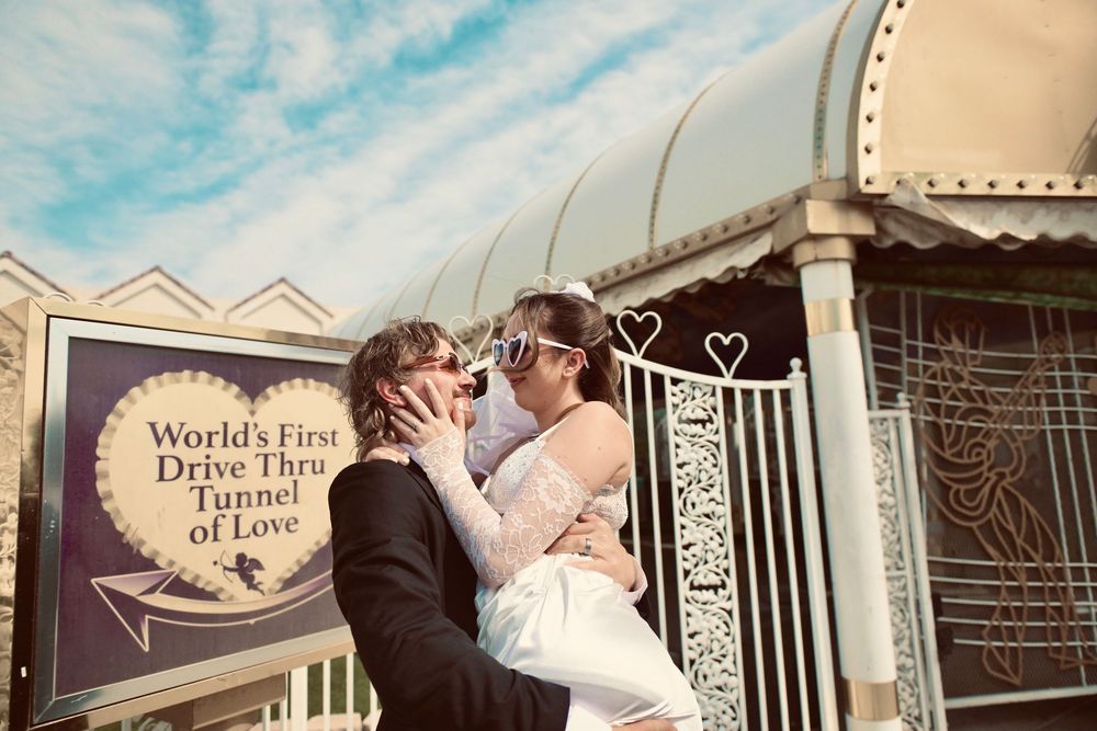 Newlyweds kissing outside the World's First Drive Thru Tunnel of Love chapel in Las Vegas.