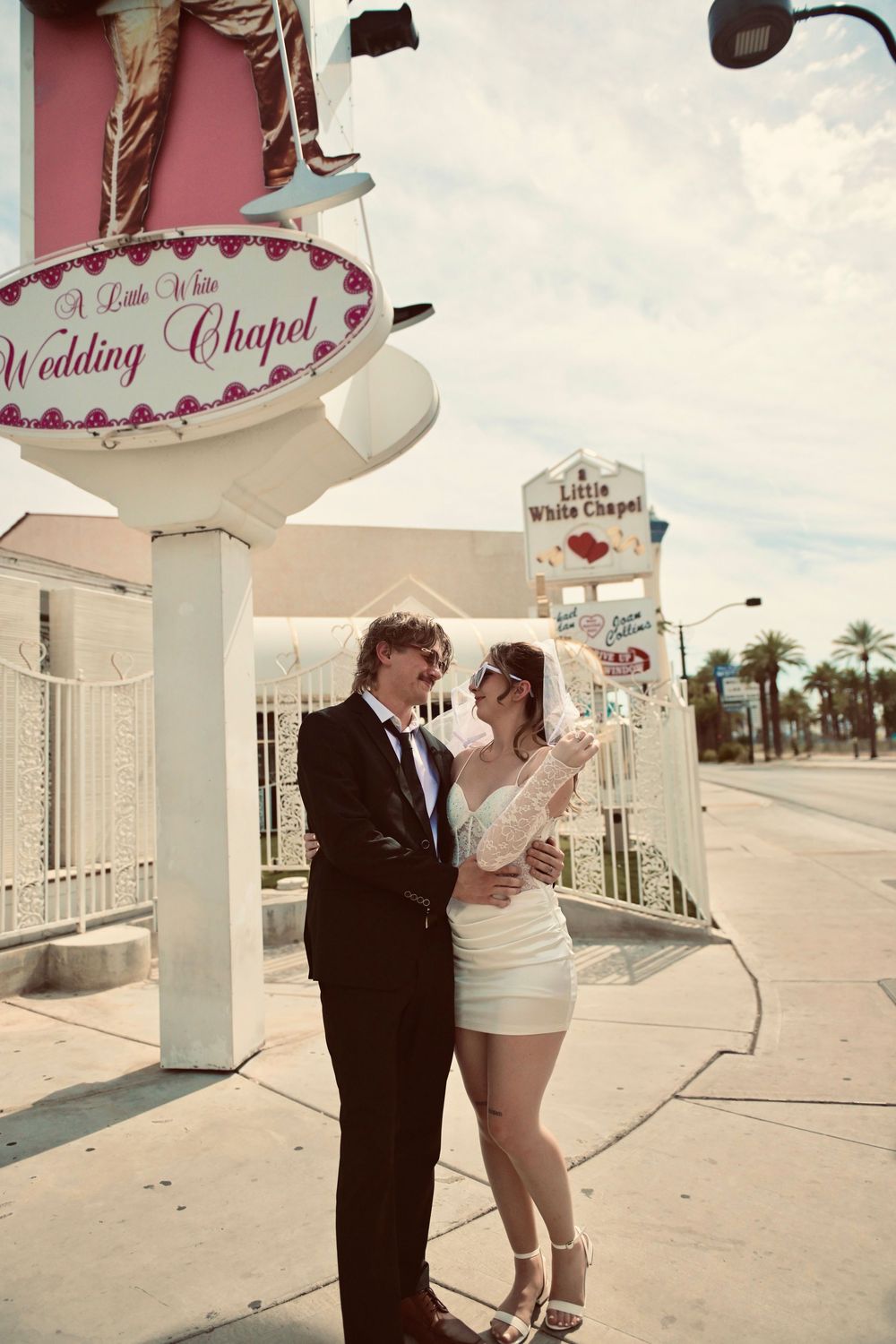 Newlywed couple embraces outside the Little White Wedding Chapel on the Las Vegas Strip.