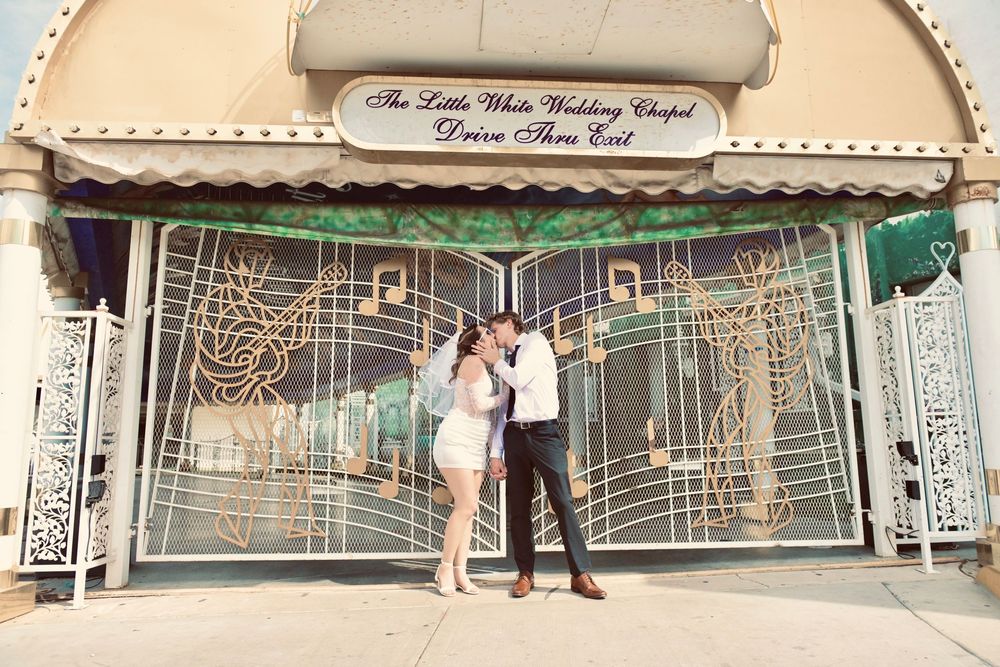 Couple kissing outside The Little White Wedding Chapel in Las Vegas, Nevada.