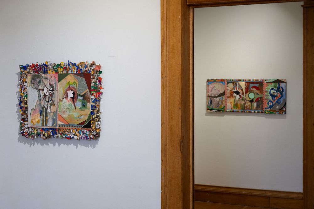 Gallery wall displaying two colorful mixed-media artworks with textured frames in a white-walled exhibition space.