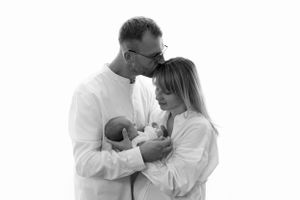 Black and white portrait of family sharing intimate moment together.
